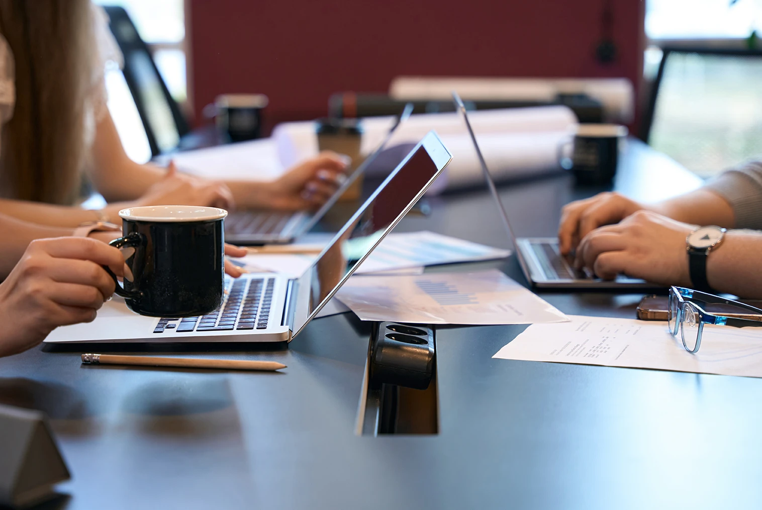 team-typing-on-laptops-in-workplace